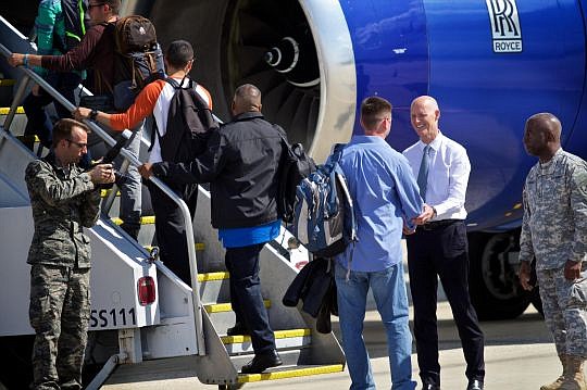 Gov. Rick Scott shakes hands with members of the 125th Fighter Wing of the Florida Air National Guard who were deployed Monday to Europe to support Operation Atlantic Resolve. (Photo by WJXT TV-4)