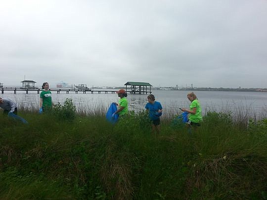 volunteers clean up along the banks of the St. Johns River and around the grounds at Blue Cypress Park on University Boulevard North.