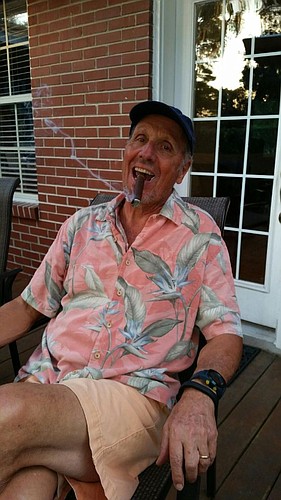 Retired Circuit Judge Brad Stetson enjoys a cigar on his back porch.