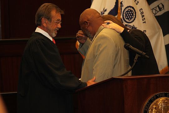 Full of emotion, James Knuckles is consoled by Magistrate John Sampson and another after receiving his certificate honoring his graduation from the 4th Circuit Veterans Treatment Court. Knuckles and Darryl Woods graduated from the program Wednesday at...