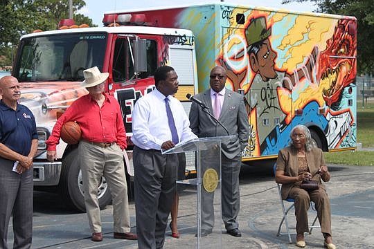 Mayor Alvin Brown, at podium, talks Monday about the benefits of expanding hours at community centers and for summer programs. He's surrounded by, from left, Jon Heymann, Jacksonville Children's Commission CEO; attorney Steve Pajcic; Reggie Lucas, Rec...