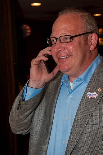 Scott Wilson takes a congratulatory call after defeating Ramon Day in District 4.
