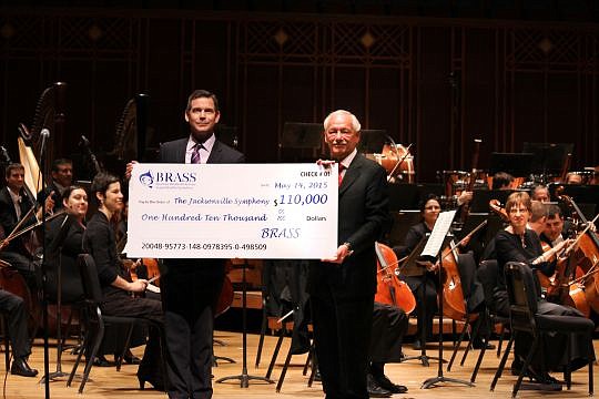 Robert Massey, left, Jacksonville Symphony Association president and CEO, accepts a check from Michael Imbriani, president of Beaches Residents Actively Supporting the Symphony.