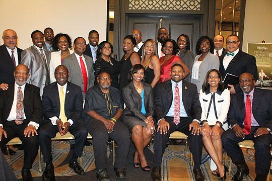 Members of the D.W. Perkins Bar Association with attorney Benjamin Crump, seated and second from left, who served as the keynote speaker for the group's annual foundation banquet. Top row from left: U.S. District Judge Brian Davis; Reginald Estell; Wi...