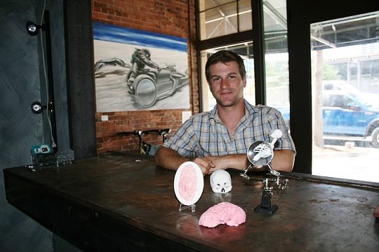 Josh Weinberger with a few 3-D models he created through his business in Downtown Jacksonville.