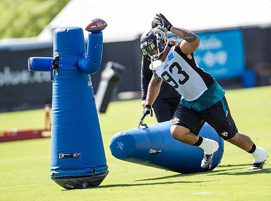 Defensive end Tyson Alualu participates in a drill.