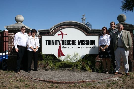 Trinity Rescue Mission officials say the nonprofit is operating in the black now in large part because of a partnership between the Community Excellence Alliance and the University of North Florida. From left are Community Excellence Partnership found...