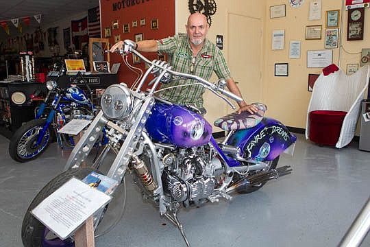 Italian motorcycle builder Fabrizio "Sugar" Favre opened a shop in Jacksonville in May, realizing his dream of coming to the United States. He's pictured with a Honda Gold Wing he built as a memorial to a friend.