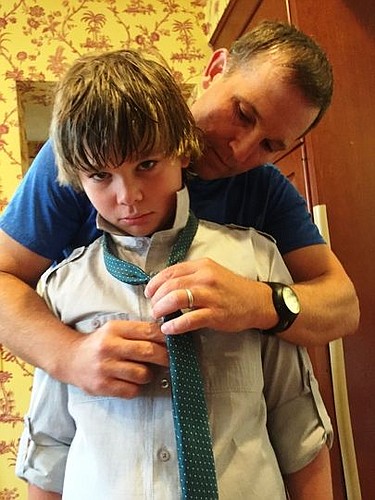 Boyd Curry gets a little help with his tie from his father as the family prepared to leave for Lenny Curry's inauguration as Jacksonville mayor.