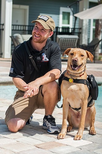 Hugh Borchers, the kennel master for K9s For Warriors, and his partner, Guinness. They are graduates of the program.