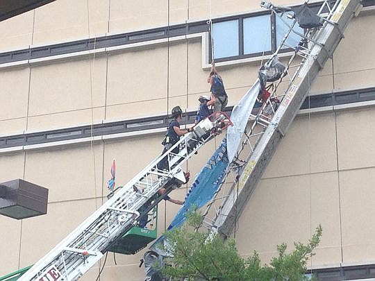 The Jacksonville Fire and Rescue Department helped two workers  who were left stranded when scaffolding was damaged during a thunderstorm Thursday afternoon. The men were part of a crew repairing windows at the jail.