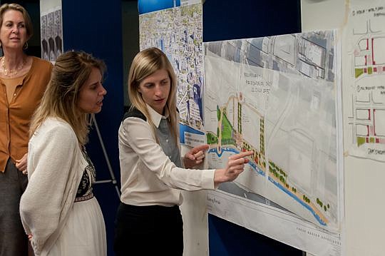 Megan O'Hara of Urban Design Associates shows the possibilities for some of the outdoor spaces at the Jacksonville Landing to Silvia De Aruojo of The Art Center Cooperative. Downtown Investment Authority board member Doris Goldstein is in the back.