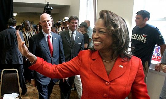 Jennifer Carroll waves after being sworn in as lieutenant governor in January 2011. In the background is Gov. Rick Scott. Carroll said she was forced to resign after being questioned in the Allied Veterans of the World gambling and money laundering in...