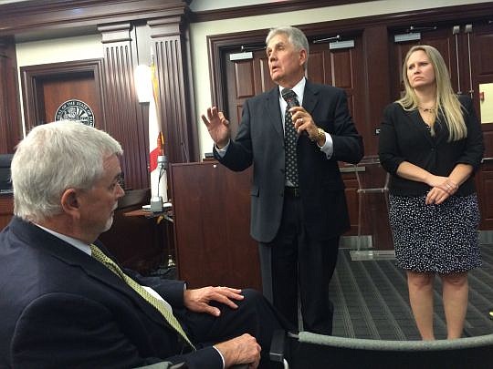 As 4th Circuit Chief Judge Mark Mahon and Krystal Watson look on, 8th Circuit Chief Justice Robert Roundtree discusses changes in online access to public records Wednesday during an informational meeting at the Duval County Courthouse. Watson is Duval...