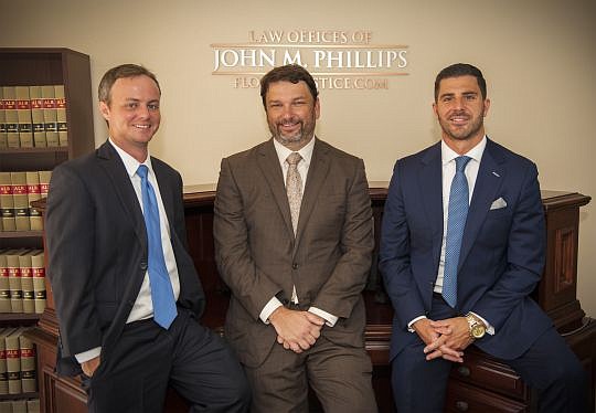 Attorneys with The Law Offices of John Phillips, center, include Reid Hart, left, and newcomer, Matt Hunt, who joined the firm last week.