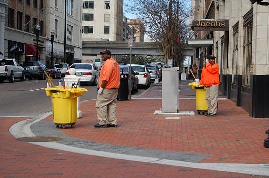 The ambassadors in their bright orange shirts are a familiar sight in Downtown. They are part of Downtown Vision Inc.'s effort to make the urban core clean, safe and a better place to live, work and invest.