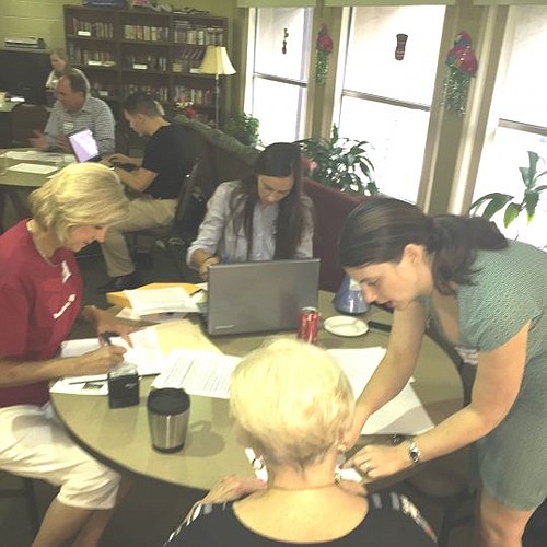 Volunteers Lisa Hunt, Rachel Sussman and Angela Grewal assist residents at PSI Mandarin Center with advance directives documents.