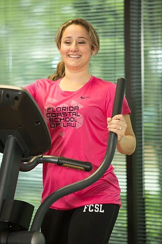 Florida Coastal School of Law student Lily Morgan uses the elliptical machine at the school's gym.
