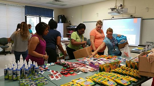 Teachers at Woodland Acres Elementary School select school supplies donated by Main Street America Group.