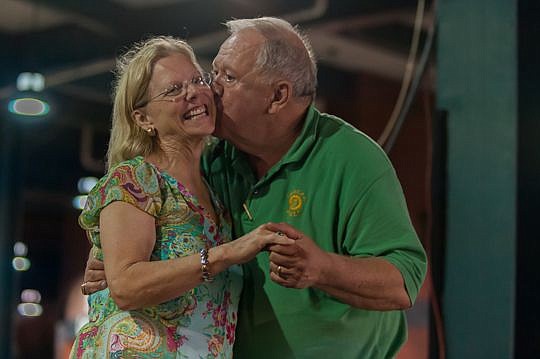 Bragan sneaks a kiss while dancing with his wife, Nancy. He met her while making a visit to Hyde Park Elementary School in the late 1990s. They were married in a church near the Baseball Grounds of Jacksonville and their reception was on the ballpark'...
