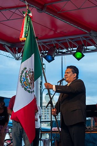 The Consulado de Mexico waves the nation's flag as the country's national anthem was performed during the Mexican Independence Day event.