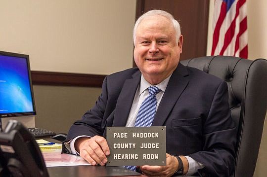 Circuit Judge Lawrence Page Haddock Jr. holds the name plate his father used on his hearing room. The younger Haddock used the name plate during his seven years as a county judge.