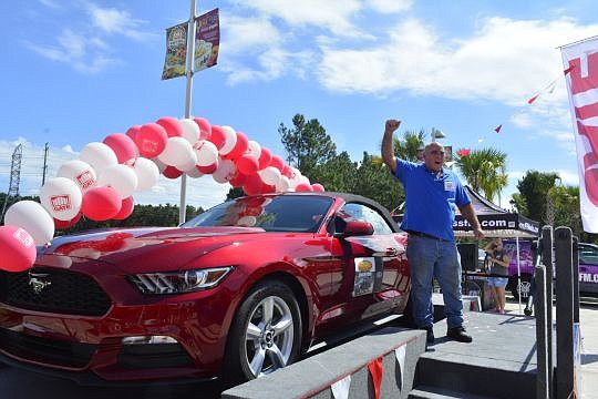 Darrell Smith celebrates after winning a new 2015 Ford Mustang convertible in the Gate Drive Your Dream Mustang Giveaway.