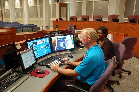 City Council Information Systems Administrator Steve Cassada and Cheryl Brown, council director, at the video and audio control panel in City Hall.