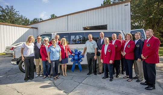 Volunteers from The Players visited Angelwood to deliver a $10,000 donation and a new van.