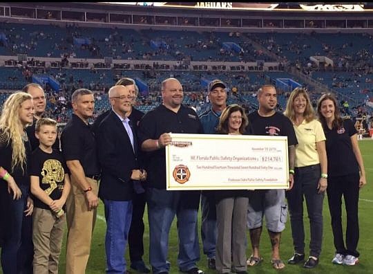 A check presentation from Firehouse Subs Public Safety Foundation was part of the pre-game activities at the Jacksonville Jaguars game Nov. 19 at EverBank Field.
