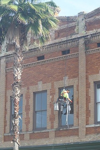 Robert Barley, a supervisor for Advanced Coating &amp; Caulking, rappelled off the building at 107 E. Bay St. to repair the seals on the windows. The company re-caulks windows on about a dozen Downtown buildings each year.