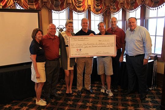Professional golfers and local duffers competed in the 18th annual Monique Burr Foundation for Children's Champions for Child Safety Pro Am Golf Tournament. Pictured, from left, are Lynn Layton, executive director of the foundation; PGA Tour golfer Ma...