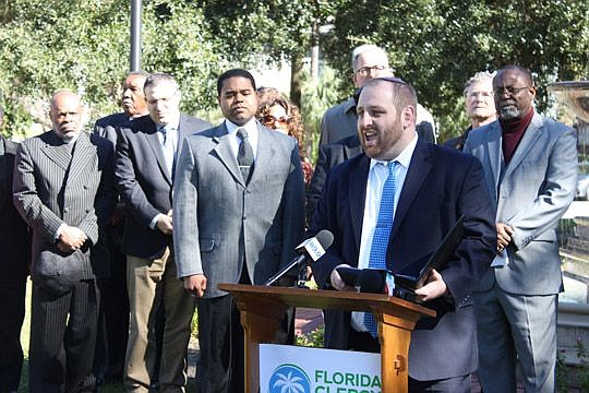 Rabbi Howard Tilman of the Jacksonville Jewish Center is joined Monday by more than a dozen other faith leaders who are supporting expansion of the city's anti-discrimination law.