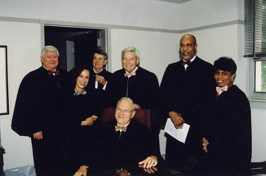 Former Florida Supreme Court Chief Justice Major Harding, seated, gave the eulogy at the funeral of his former court colleague, Leander Shaw, standing second from right. Shaw who practiced in Jacksonville died in December. Also pictured are other memb...