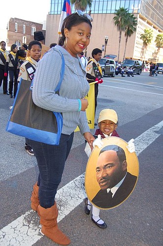Alexis Miller and her 3-year-old daughter, Angel, attended the parade for the first time. They walked alongside children enrolled in the Adventurer and Pathfinder clubs, a Bible-based service organization for students Pre-K through high school.