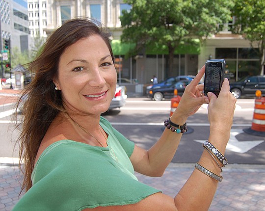 Photo by Max Marbut - Missy Hager, director of "PhotoJax 2011," a festival celebrating photography. Part of the event is an outdoor exhibit of photographs taken with cellphone cameras and the public is invited to participate.