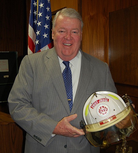 Photo by Max Marbut - Chief Circuit Judge Donald R. Moran Jr. was visited by a group of firefighters last week - and they were bearing a gift.