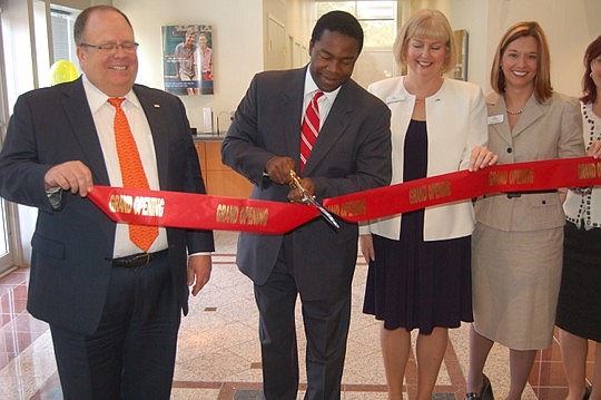 Photos by Max Marbut - Mayor Alvin Brown cut the ribbon at the new SunTrust bank retail branch Friday Downtown. He was joined by SunTrust North Florida Region President David Mann, Retail Line of Business Manager Linda Persandi and Branch Manager Mega...