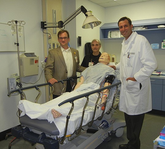 Photos by Karen Brune Mathis - Dr. Brent Seibel, Simulation Center Director Bruce Nappi and Dr. Andy Godwin with one of the 18 full-body high-fidelity "robots" on which University of Florida College of Medicine students and physicians in the UF&amp;Sh...
