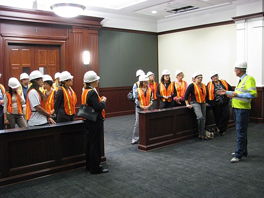 Photos by Joe Wilhelm Jr. - Duval County Courthouse Project Manager Dave Schneider describes the features of a C-3, or county courtroom, to members of the Jacksonville Women Lawyers Association. The courtroom was 95 percent complete at the time of the...