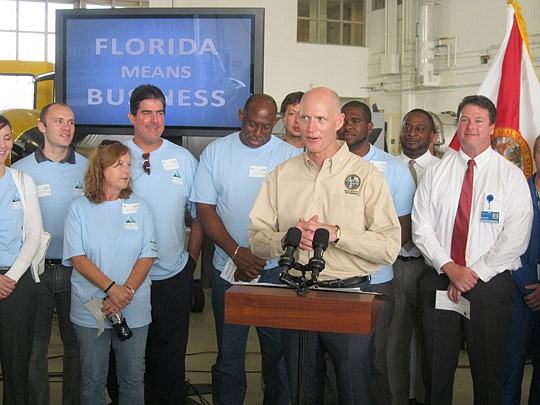 Photo by David Chapman - Gov. Rick Scott was in Jacksonville for about an hour Thursday at Florida State College of Jacksonville's Aviation Center of Excellence hangar at Cecil Center South to promote his 2012 agenda for jobs and economic growth.