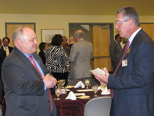 Photo by Joe Wilhelm Jr. - Wells Fargo Senior Economist Mark Vitner talks with Economic Roundtable of Jacksonville President Bob Brigham, who is chief administrative office of Mayo Clinic, Tuesday at the Jacksonville University Davis College of Busine...