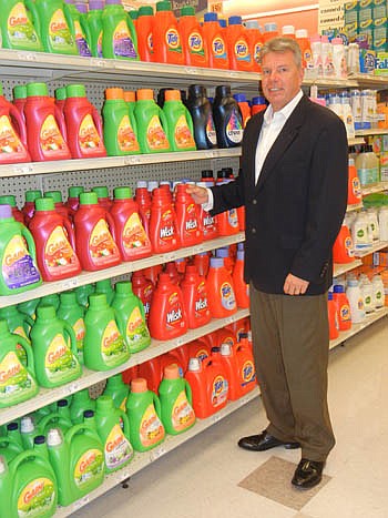 Photo by Karen Brune Mathis - Acosta Sales &amp; Marketing Executive Vice President Paul Price shows some of the company's product placement at a Winn-Dixie store.