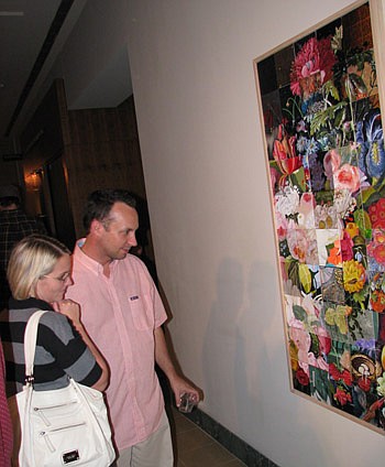 Photos by Joe Wilhelm Jr. - Artist Jason Tetlak and Alicia Linquist look at piece created by 50 artists under the age of 50 to celebrate the 50th anniversary of The Cummer Museum of Art &amp; Gardens. Tetlak contributed a square to the project.