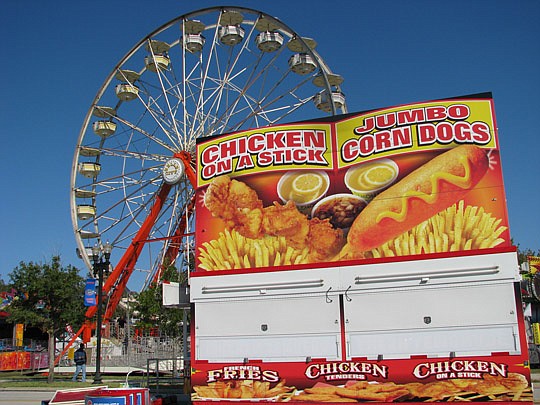 Photos by Joe Wilhelm Jr. - The Greater Jacksonville Agricultural Fair plans to serve up helpings of food and fun when it opens at 5 p.m. today. Pictured in the background is one of Belle City Amusement's newest attractions, the Giant Wheel.