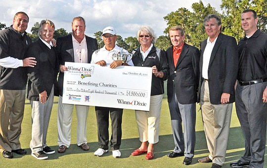 Tournament representatives, sponsors and PGA Tour officials displayed an oversized check to demonstrate the amount raised for charity by the second annual Winn-Dixie Jacksonville Open presented by Planters. From left: Bill Hughes, general manager, TPC...