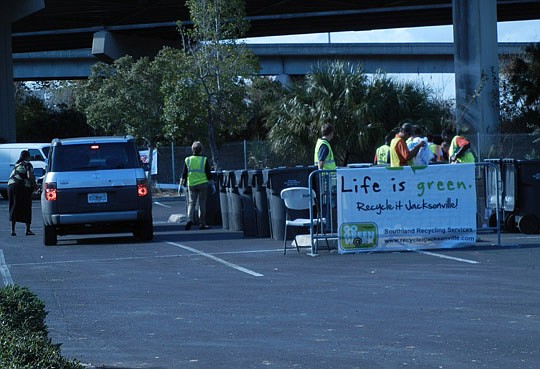 Photos by Karen Brune Mathis - From 11 a.m.-6 p.m., Tuesday, almost 20 volunteers with Bank of America, Keep Jacksonville Beautiful and other organizations helped people unload boxes and bags of recyclables from their vehicles at the Osborn Center as ...