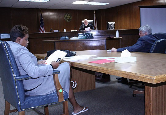 Photos by Joe Wilhelm Jr. - During a mock hearing Tuesday, Judge Angela Cox (left) displays some of the habits and wardrobe not recommended for the courtroom. The Jacksonville Bar Association's Young Lawyers Section "Afternoon at the Courthouse" was c...