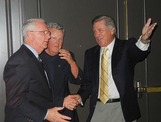 Photos by Karen Brune Mathis - Daniels assured the crowd of 350 people he was surprised when he arrived at the Omni Hotel ballroom with friends Tom Healy and Mike Hartley.