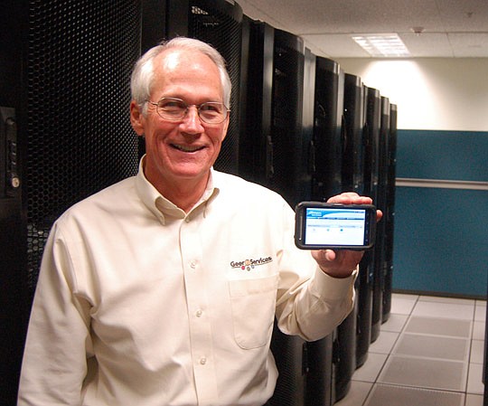 Photo by Max Marbut - Geer Services President Pat Geer holds the power of a room full of computer servers in the palm